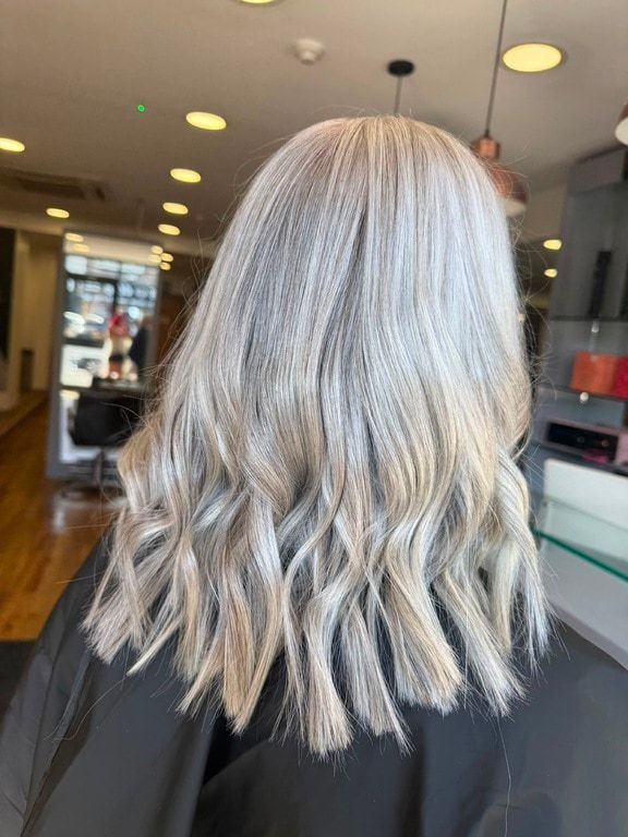 Cool icy blonde on mid-length waves, coloured at Thatchairs Hair & Body