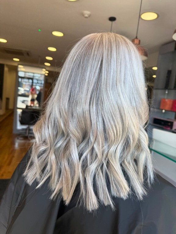 Cool icy blonde on mid-length waves, coloured at Thatchairs Hair & Body